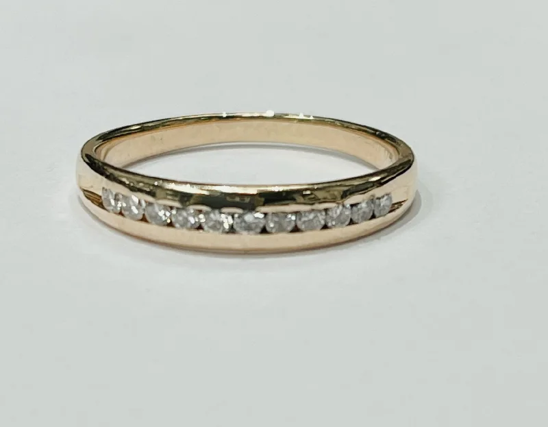 Simple engagement rings for women-This delicate diamond channel band features a 14k yellow gol...